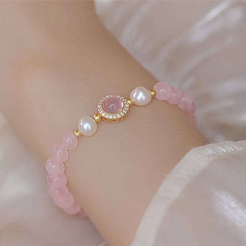 Aquamarine crystal bracelet with mixed materials including pink beads, white pearls, and peach blossom elements