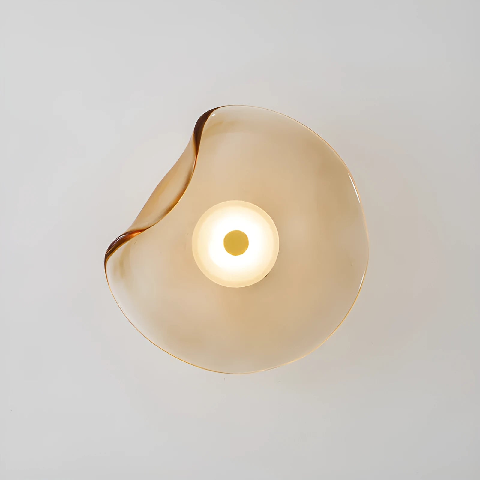 Round glass wall lamp in a choice of colours for bedroom bedside lighting.