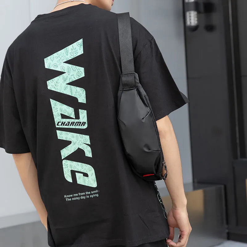 Men's black Oxford cloth crossbody waist pack showing interior phone and ID pockets