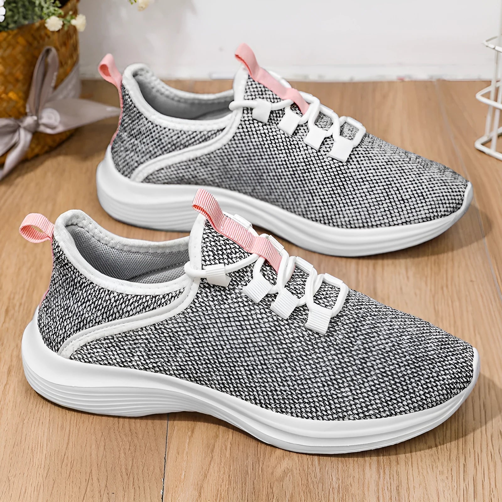 Women's low-top casual sneakers in black, grey, or pink with breathable mesh upper and lightweight EVA sole.