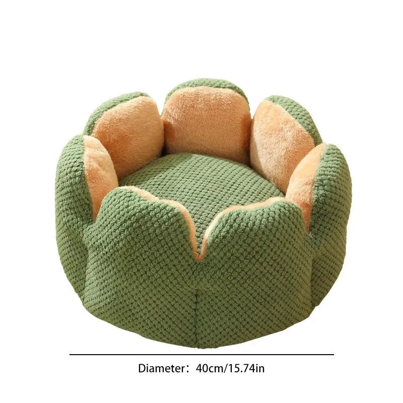Green cactus petal shaped plush dog bed with a non-slip bottom on a wooden floor.
