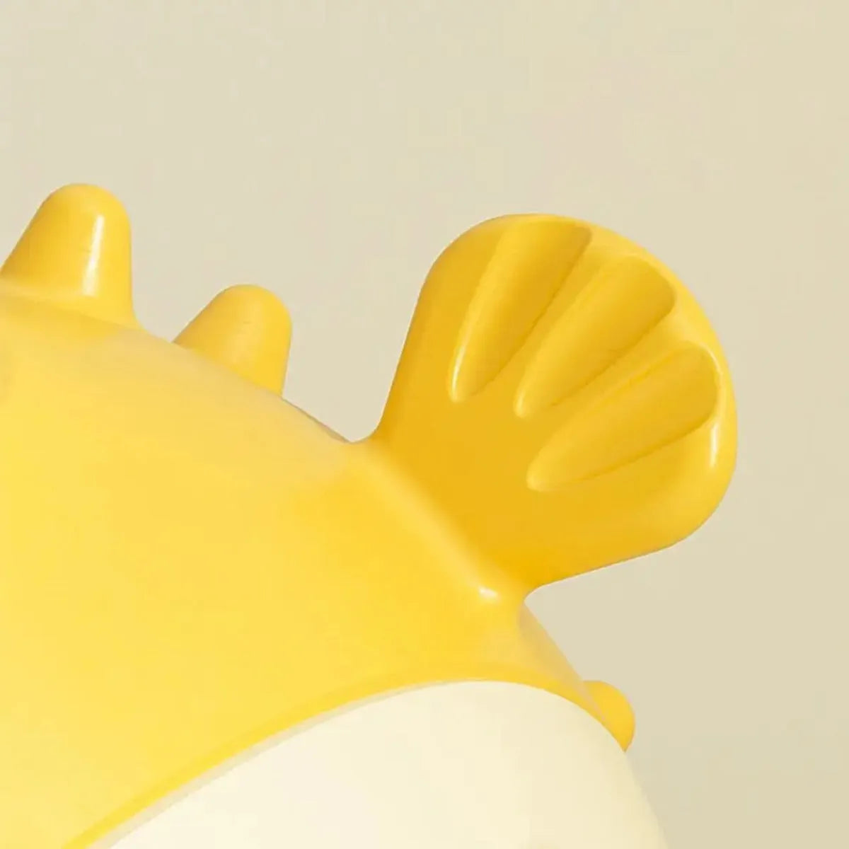 Yellow fish-shaped vinyl dog chew toy with textured surface and squeaker for aggressive chewing dogs