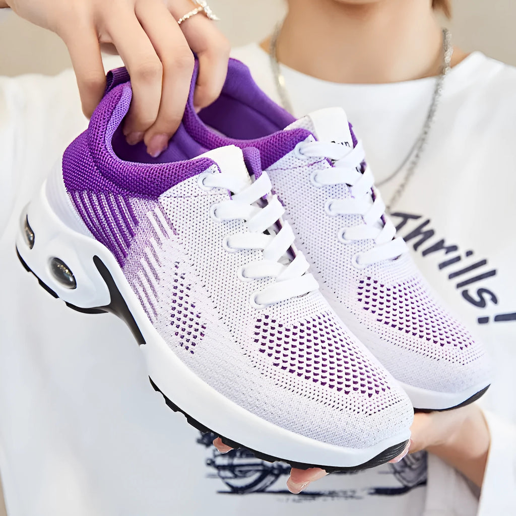 Women's Flyknit casual running shoes in pink with lace-up front and flat PVC sole.