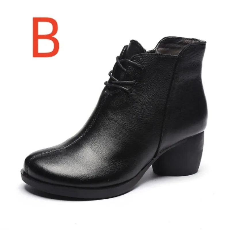 Brown women's leather Martin boots with a thick round heel and round toe on a wooden floor.