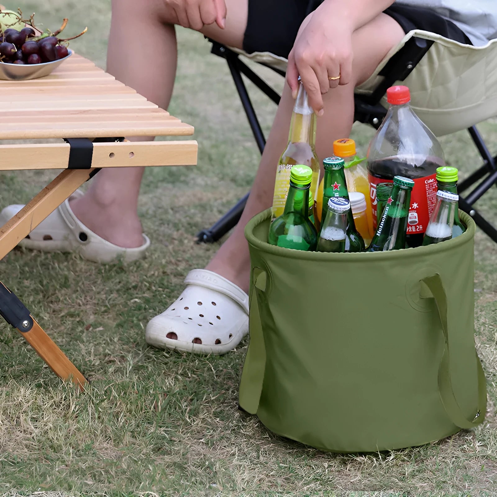 Army green folding telescopic storage duct with PVC mesh construction and ribbon handles