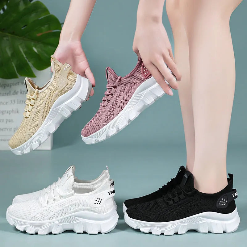 Women's white flyknit casual sneakers with thick PVC sole and round toe, showing lace-up front.