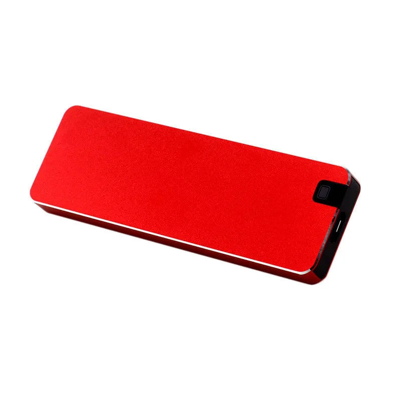 White metal portable external SSD hard drive with USB cable on a grey background