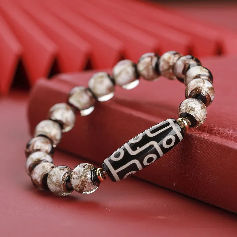Close-up of a coloured glaze bracelet with traditional Chinese snake design and multi-coloured beads.