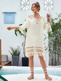 Apricot-coloured hand-crocheted long beach dress for women on a hanger.