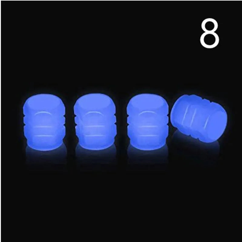 Pack of green and blue luminous rubber tyre valve caps on a car tyre valve.