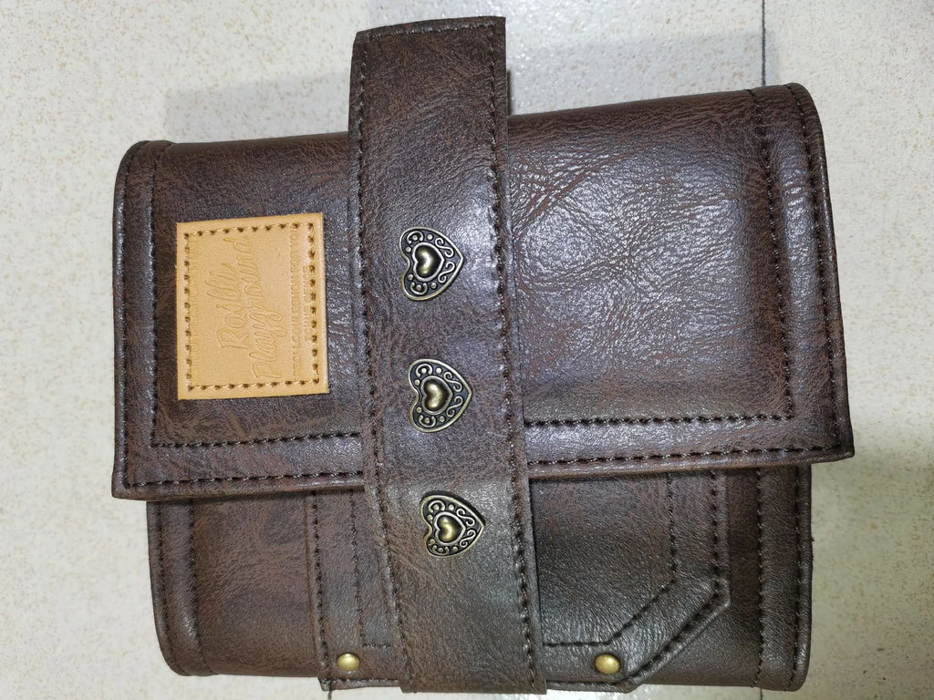 Brown PU cover A7 notebook with metal buckle closure showing loose-leaf binding and raw wood pulp pages