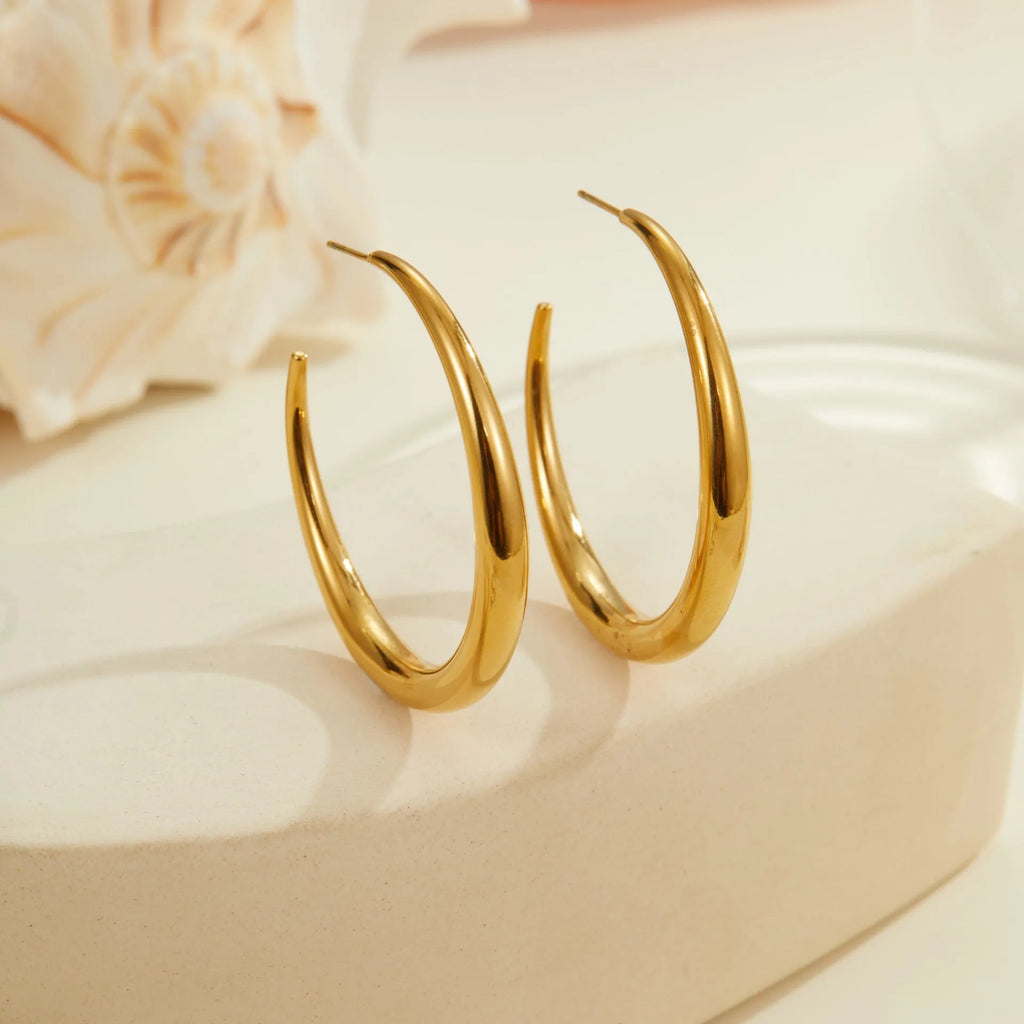 Simple round stainless steel hoop earrings for women in gold and steel colours, available in two sizes.
