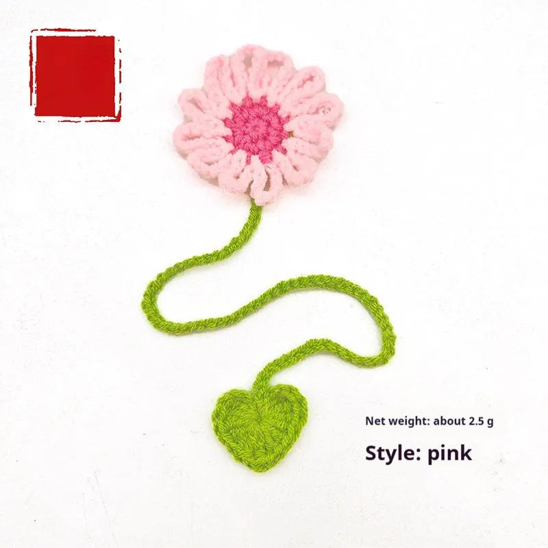 Hand-crocheted wool bookmark with flexible wire core and little daisy design in milk cotton yarn