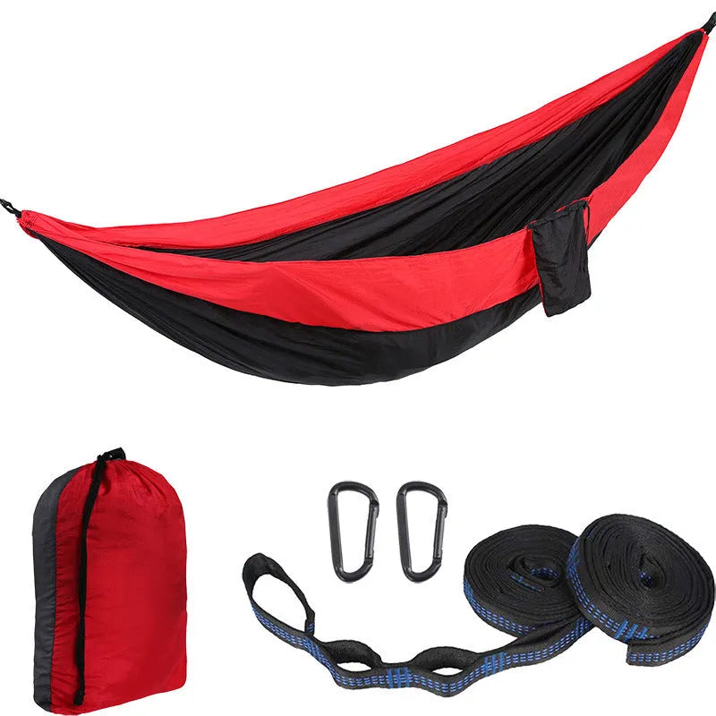 Double camping hammock with ropes and buckles shown in outdoor setting