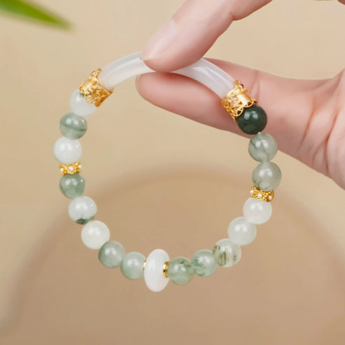 Emerald green jade bracelet with floating flower girl design in a half bracelet style.