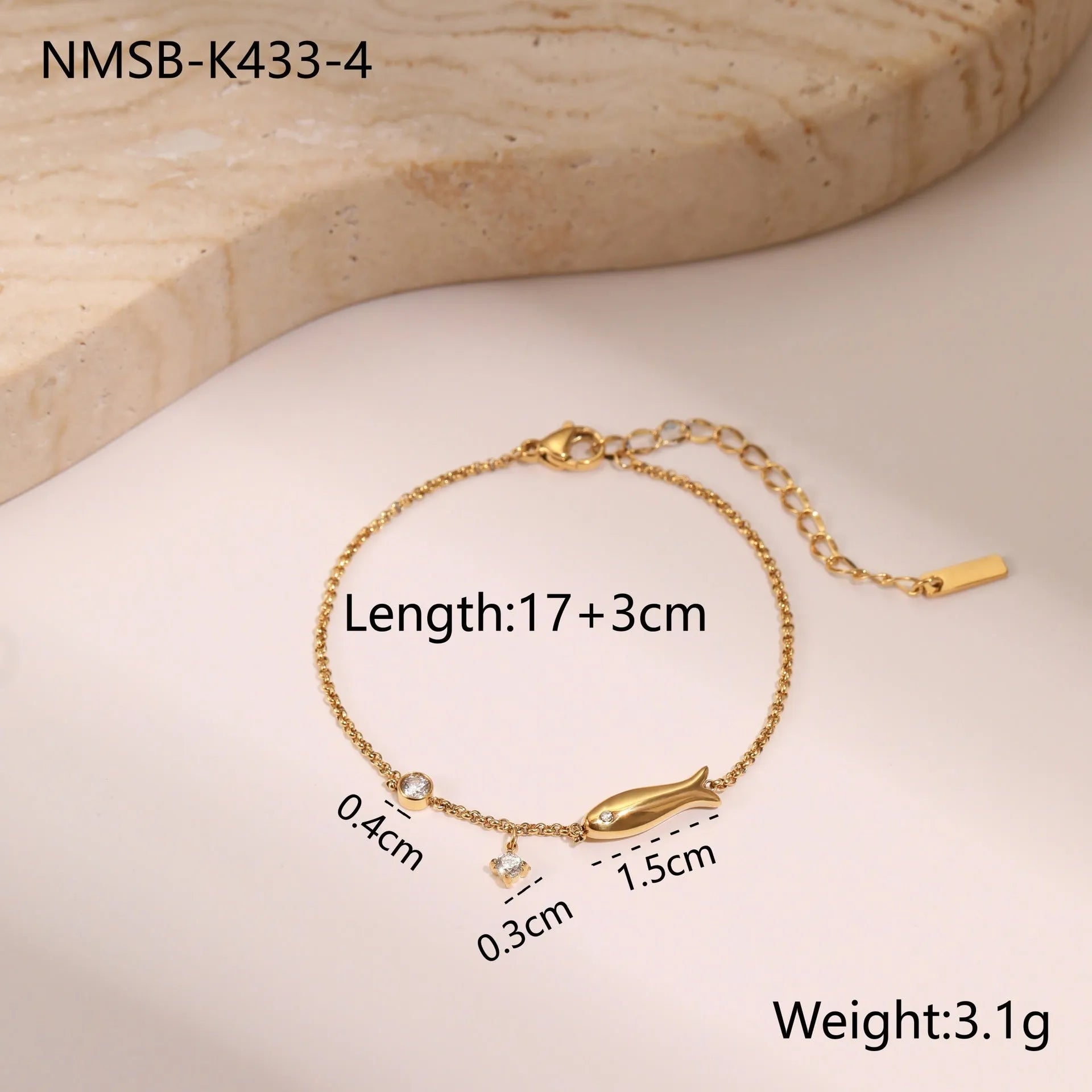 Gold plated stainless steel bracelet with a detailed zircon star pendant on a woman's wrist.
