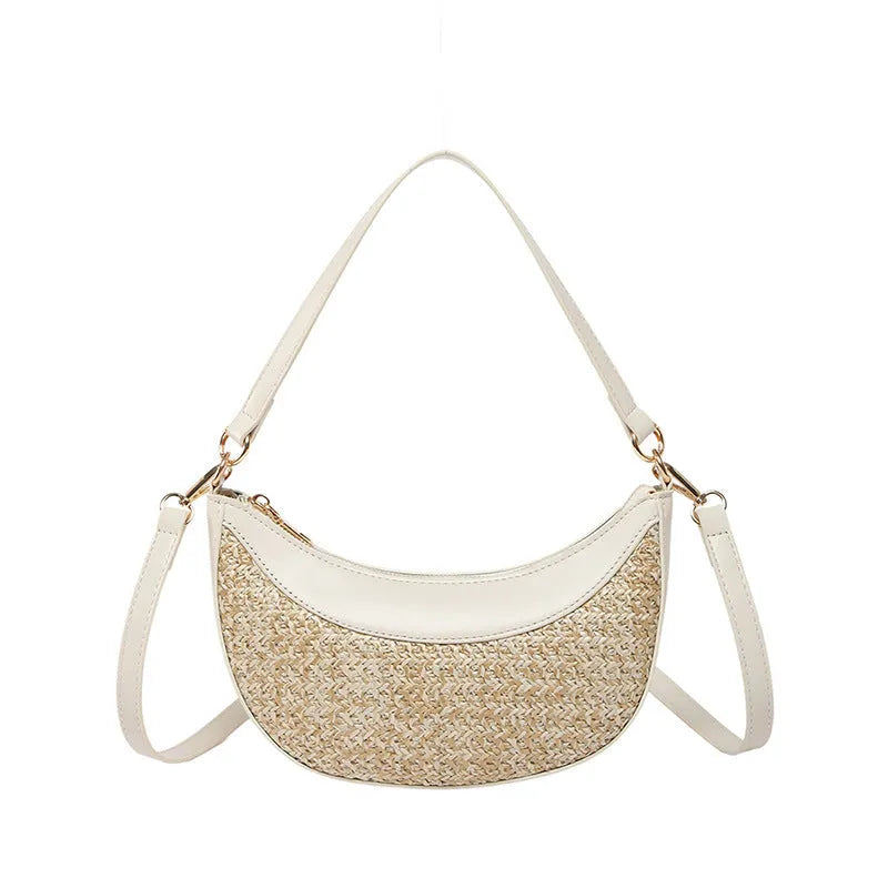Hard structured straw dumpling shaped women's crossbody shoulder bag in black with contrast stitching.