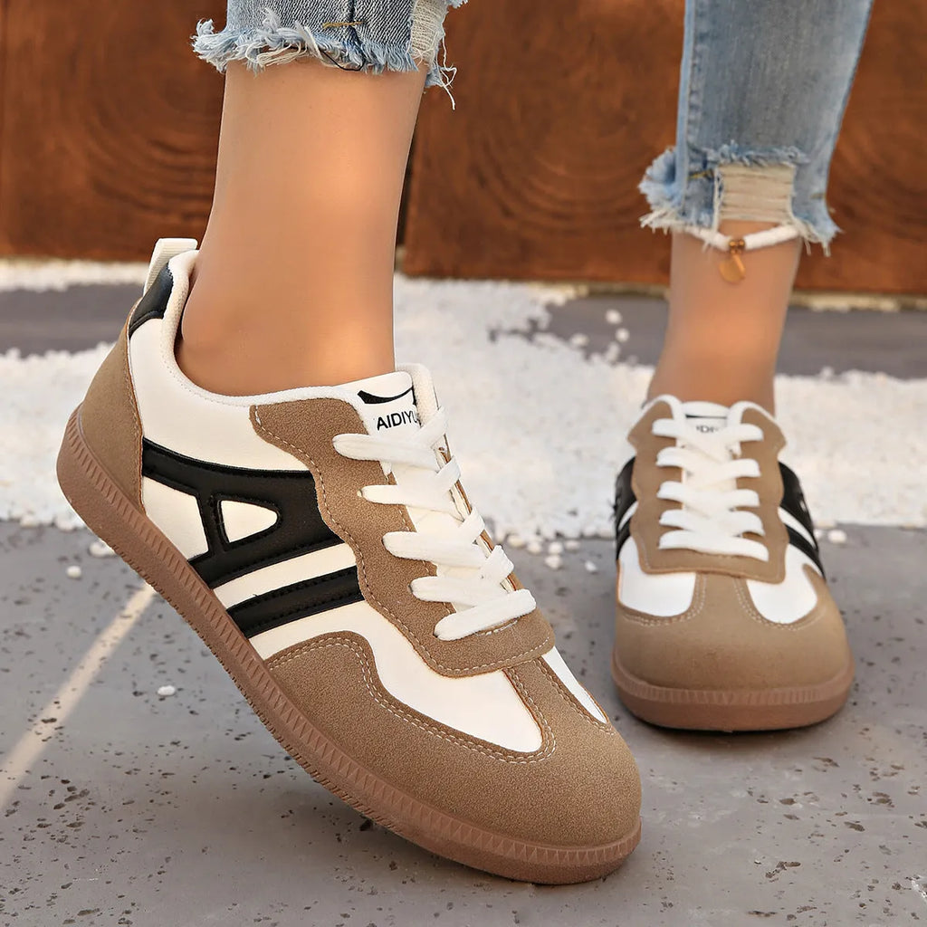 Retro women's jogging shoes in black with lace-up front, cross strap, and platform heel design