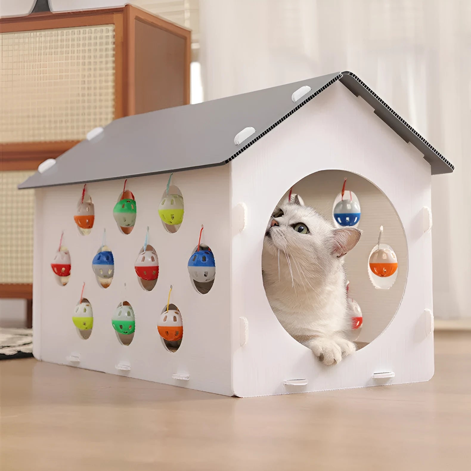 House-shaped cat scratch board with integrated bell ball and plastic tunnel forming multifunctional cat furniture