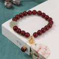 Traditional cinnabar women's bracelet with fu character centrepiece in purple and gold sand colours