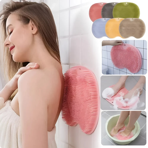Orange silicone bristle bath brush with suction cup base on a bathroom floor.
