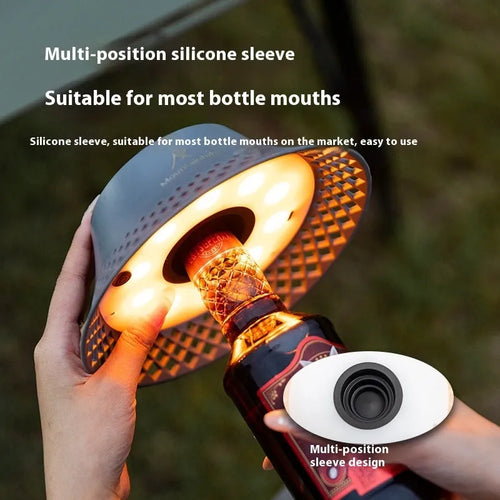 Beige wine bottle shaped camping lantern with USB-C port shown on a table.
