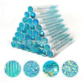 Set of coloured disposable eyelash spoolie brushes inside clear plastic storage tubes.