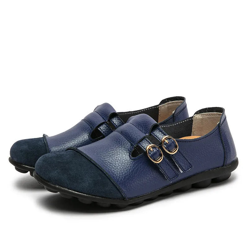 A pair of casual black flat shoes with a round toe, Velcro strap, and cow split leather upper.