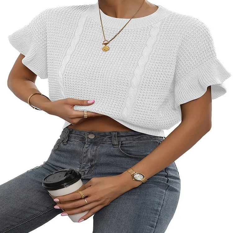 White loose knitted women's pullover sweater with ruffled short sleeves and a textured 3D pattern.