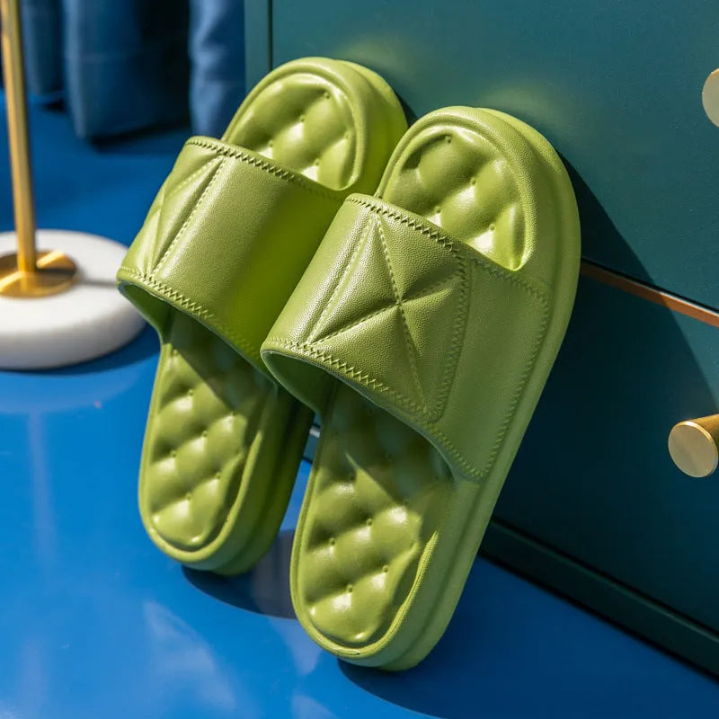 Pair of thick-soled EVA bathroom slippers in various colours, showing non-slip sole texture.