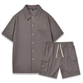 Beige polyester short sleeve top and elastic waist shorts two-piece set laid flat.