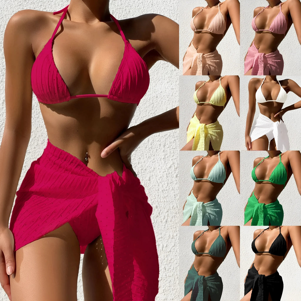 Women's three-piece halterneck swimsuit set in a solid colour with a matching mesh skirt.