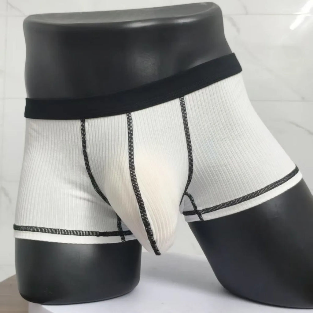 Solid colour men's boxers on a white background, showing thin breathable fabric and body-shaping fit.