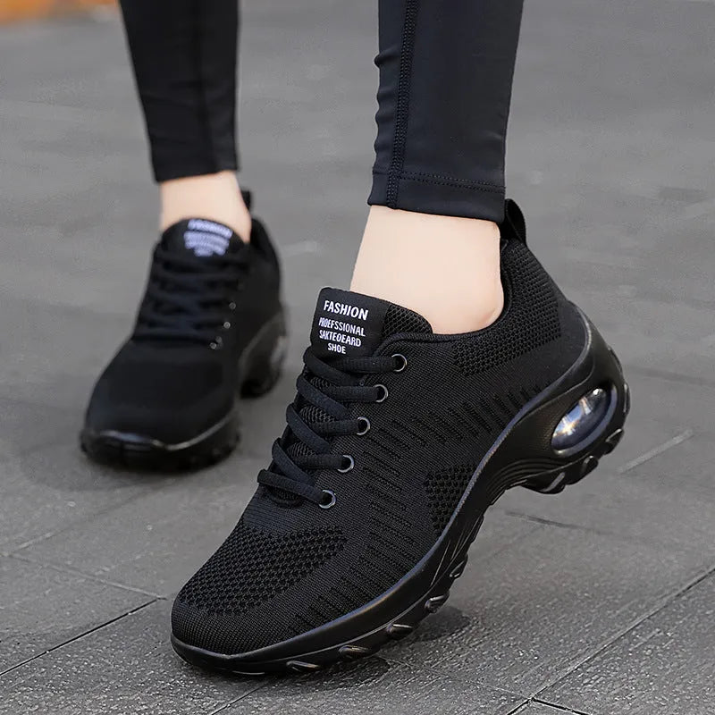 Red and black women's low-top mesh sneakers with round toe and front lace-up closure.