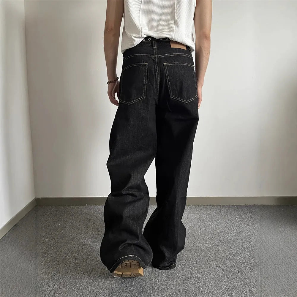 Black retro-style loose wide-leg straight-leg jeans on a hanger.
