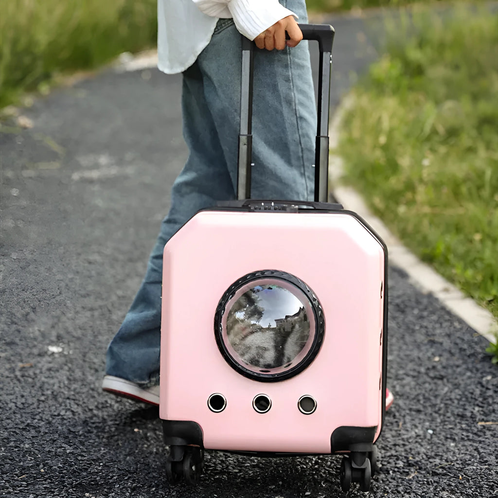 Hard-sided pink PVC pet flight case on wheels with trolley handle