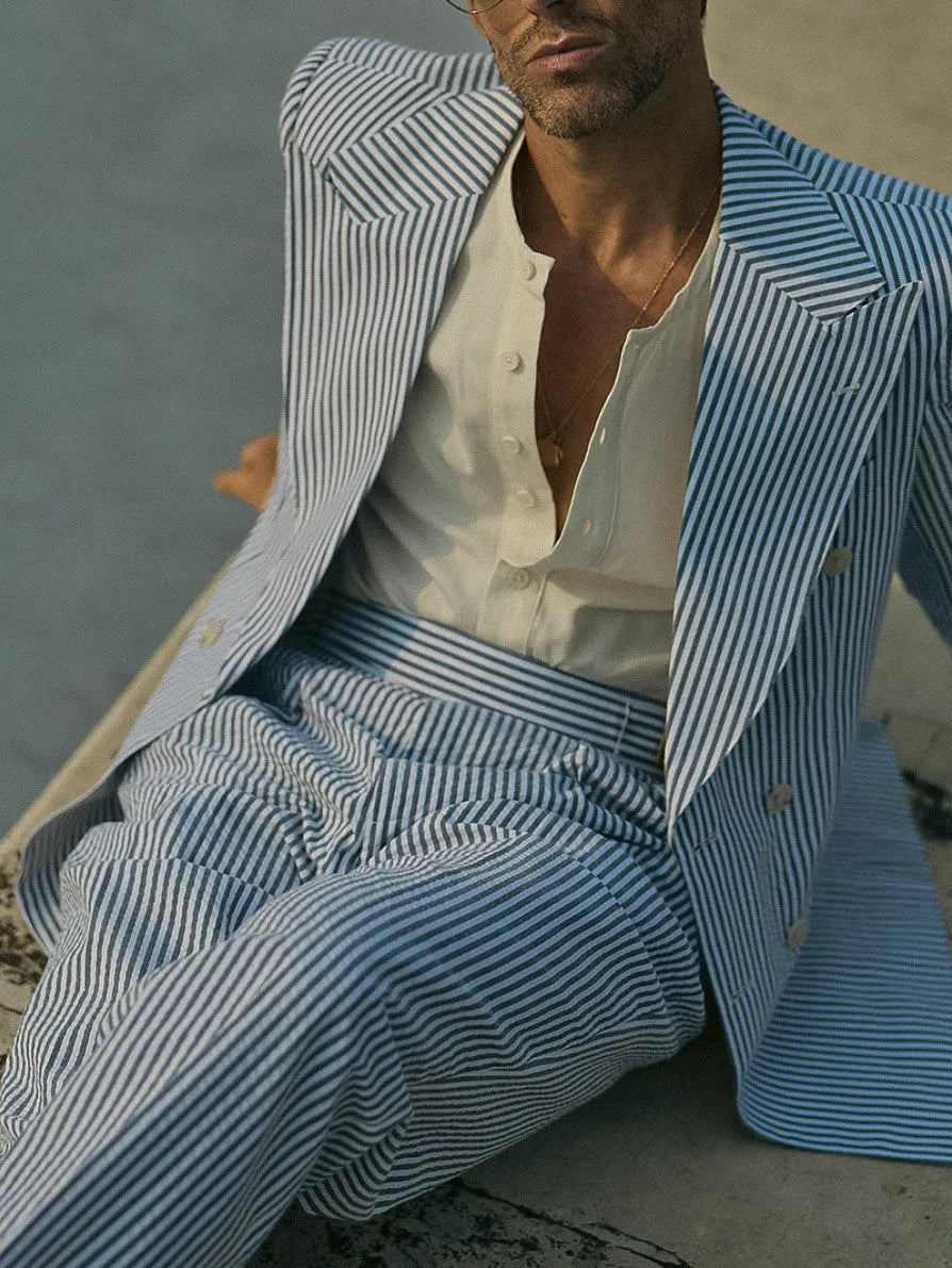 Blue and white striped polyester two-piece suit set with blazer and trousers on a hanger.