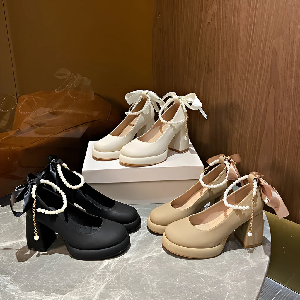 Beige women's Mary Jane shoes with a chunky heel, round toe, and ankle strap with a pearl and buckle.
