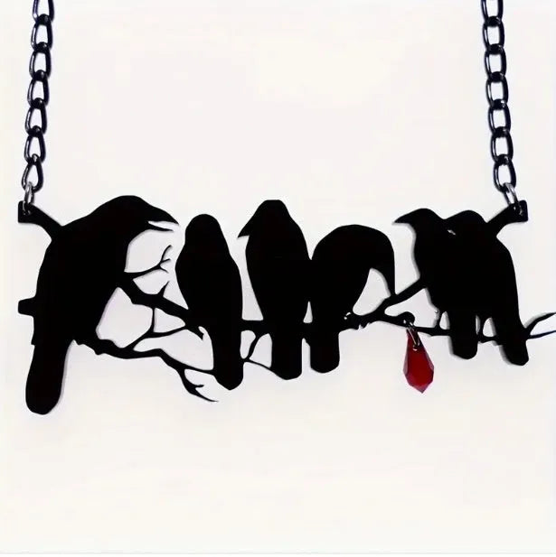 Black electroplated alloy crow pendant necklace on a cross chain for women.