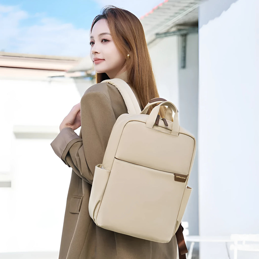 Large canvas travel backpack for women in apricot colour, showing front sandwich pocket and urban style.