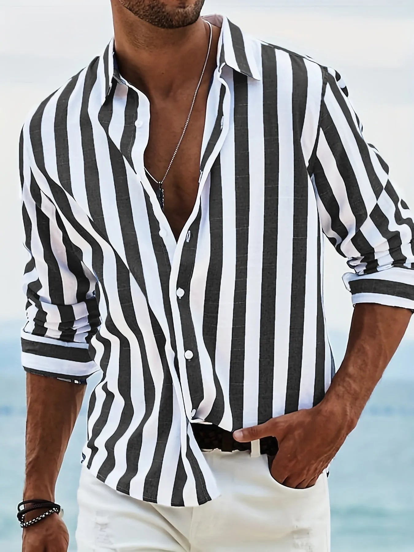 Man wearing a grey and white striped loose-fit long-sleeved casual shirt