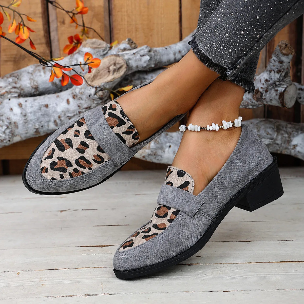 Leopard print suede slip-on pump with chunky heel in brown, shown from the side.