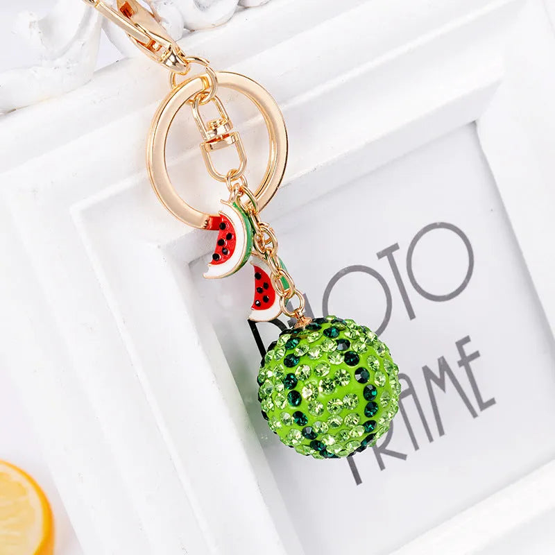 Green zinc alloy watermelon slice keychain on a white background