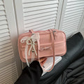 Single-shoulder flap bag in horizontal square shape with bow decoration and internal phone compartment