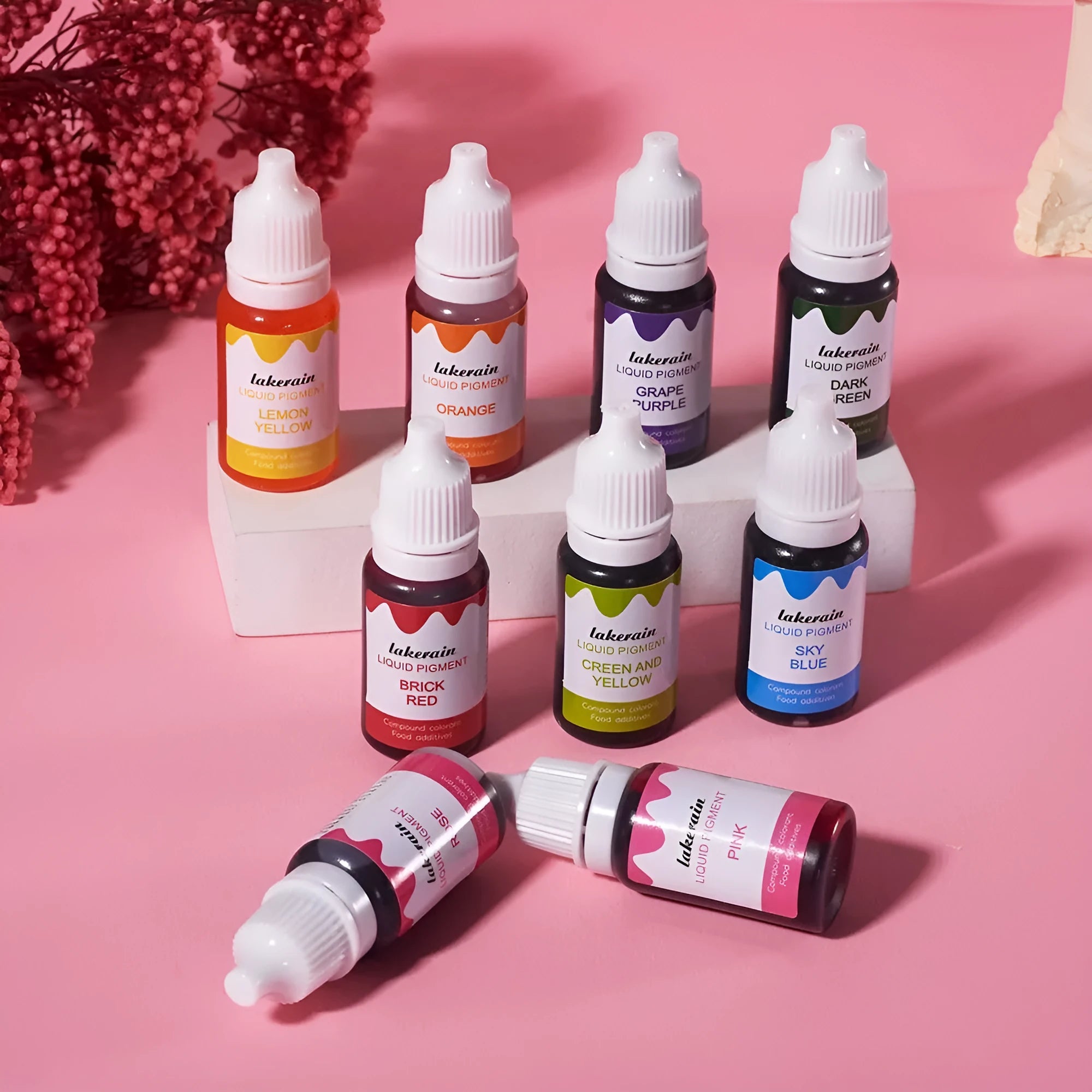 24 bottled soap pigments in rainbow colours with crafting tools and decorative accessories laid out