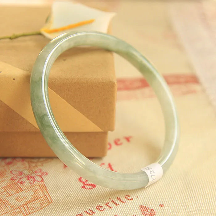 Green waxy jade geometric bracelet with Chinese-style design showing handmade construction