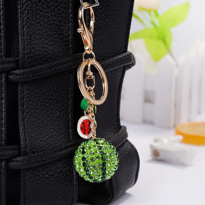 Green zinc alloy watermelon slice keychain on a white background