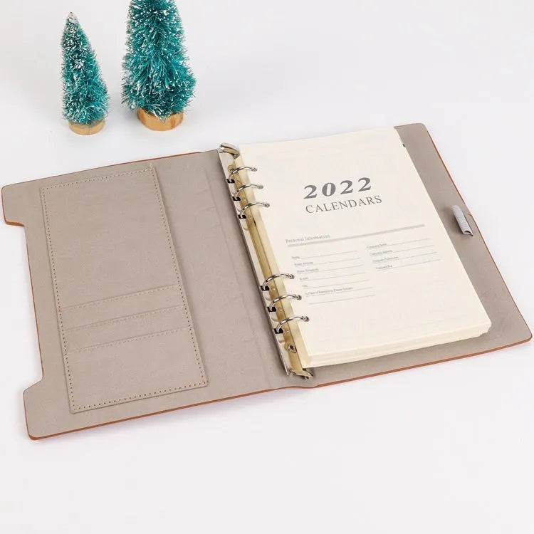 White A5 loose-leaf notebook inner pages with monthly plan layout on a plain background