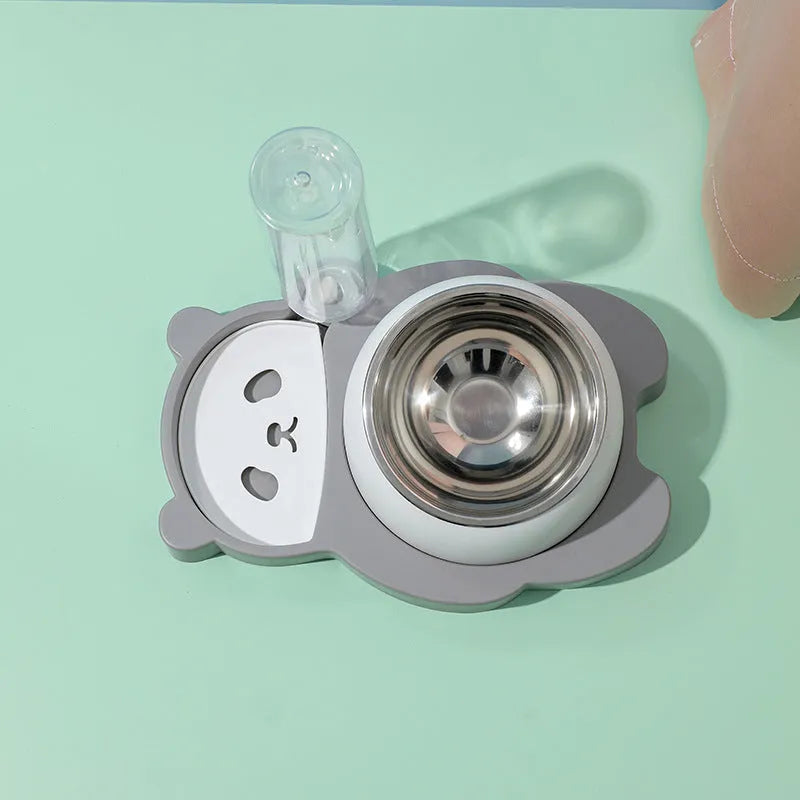 Grey panda-shaped pet feeder with tilted stainless steel bowls and a green automatic water bottle.