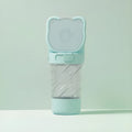 Green 3-in-1 portable pet water bottle with food container and waste bag dispenser showing rotary switch